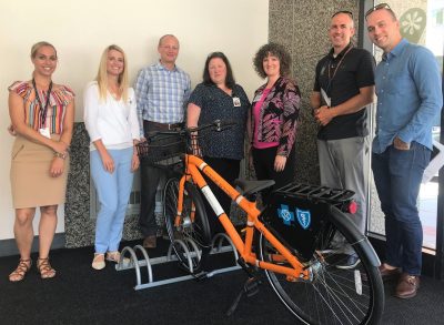 Bike Share partners posing with bike