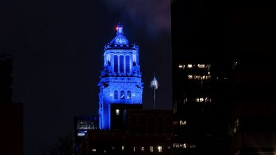 The Plummer Building lights up in blue.