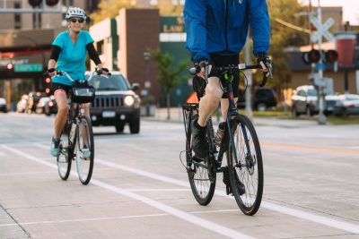 Two people biking in a bike lane on Center Street East in Rochester